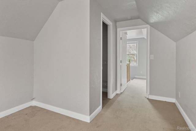 1621 Greenbrook Ln, Flint, MI 48507 - bonus room featuring vaulted ceiling, carpet flooring, a textured ceiling, and a textured wall