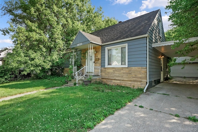 1621 Greenbrook Ln, Flint, MI 48507 - bungalow with stone siding, roof with shingles, a front lawn, and driveway