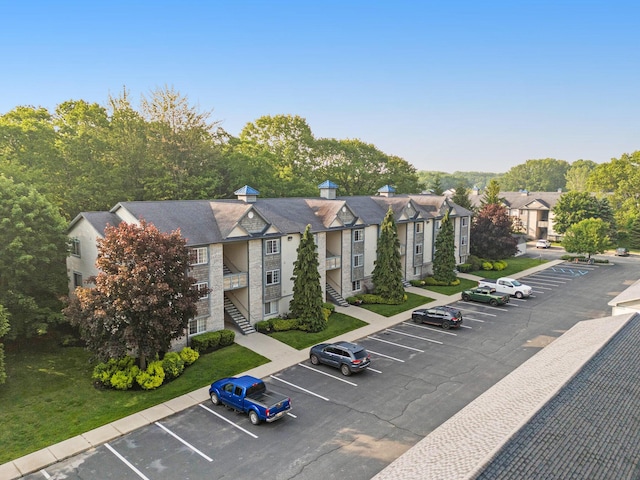 18372 N Ridge Ct Unit 12, Spring Lake, MI 49456 - view of property with uncovered parking and stairs