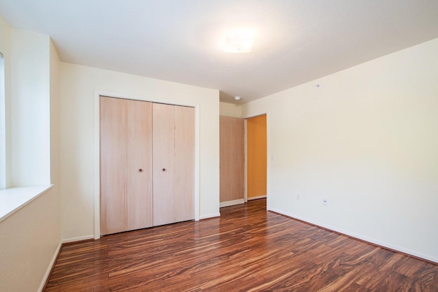 18372 N Ridge Ct Unit 12, Spring Lake, MI 49456 - unfurnished bedroom with wood finished floors, a closet, and baseboards
