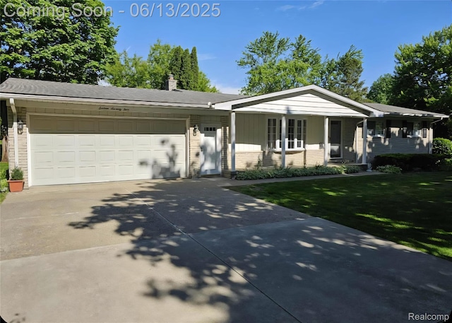 1674 Newark Ave, Pontiac, MI 48340 - ranch-style house with concrete driveway, a front yard, brick siding, and an attached garage
