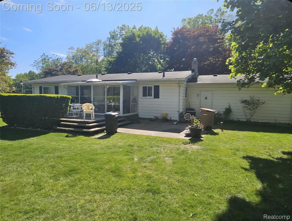 1674 Newark Ave, Pontiac, MI 48340 - rear view of property featuring a sunroom, a patio area, and a yard