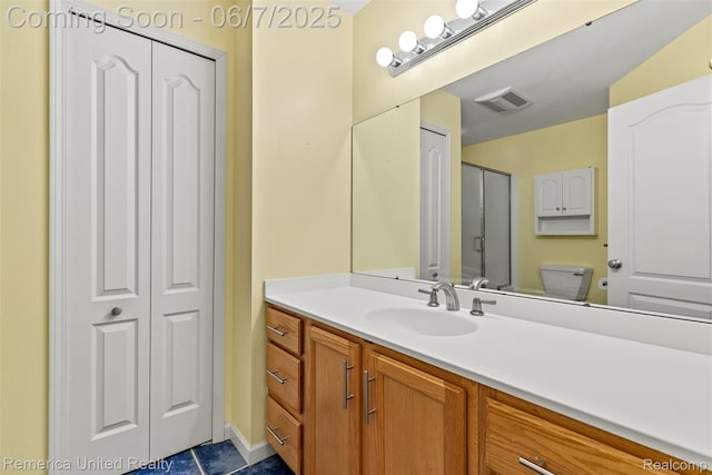 2663 Maple Forest Dr, Wixom, MI 48393 - bathroom featuring vanity, toilet, a closet, and tile patterned floors