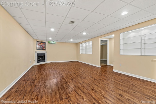2663 Maple Forest Dr, Wixom, MI 48393 - unfurnished living room featuring wood finished floors, a tile fireplace, baseboards, and recessed lighting