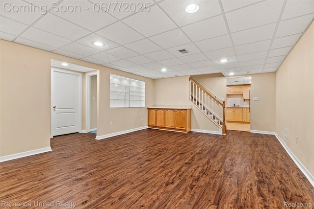 2663 Maple Forest Dr, Wixom, MI 48393 - finished basement featuring dark wood-style floors, stairway, baseboards, recessed lighting, and a drop ceiling
