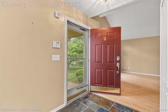 2663 Maple Forest Dr, Wixom, MI 48393 - foyer entrance with baseboards, lofted ceiling, and stone finish floors