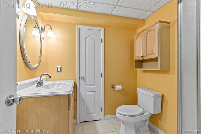 2663 Maple Forest Dr, Wixom, MI 48393 - bathroom featuring vanity, toilet, tile patterned flooring, baseboards, and a drop ceiling