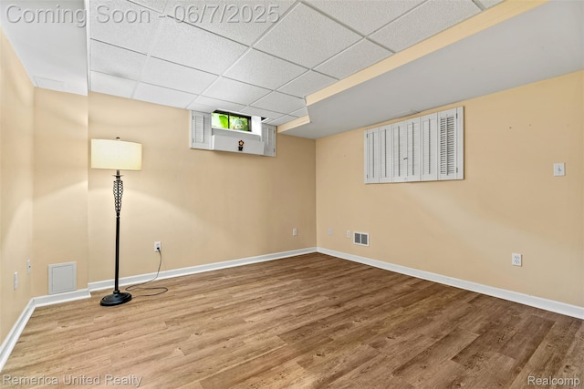 2663 Maple Forest Dr, Wixom, MI 48393 - basement featuring wood finished floors, baseboards, and a drop ceiling