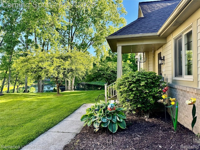 2663 Maple Forest Dr, Wixom, MI 48393 - view of green lawn with a water view and view of wooded area
