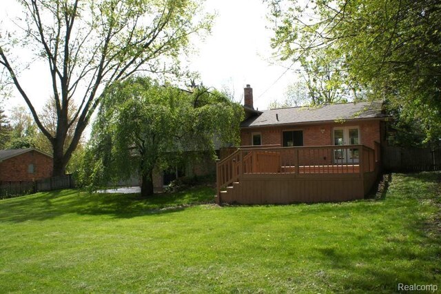 1616 Mark Hopkins Rd, Bloomfield Hills, MI 48302 - back of property with a wooden deck, a chimney, brick siding, and stairs