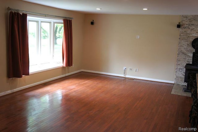 1616 Mark Hopkins Rd, Bloomfield Hills, MI 48302 - unfurnished living room with a wood stove, baseboards, wood finished floors, and recessed lighting
