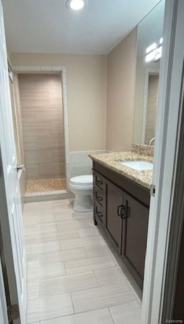 1616 Mark Hopkins Rd, Bloomfield Hills, MI 48302 - bathroom with vanity, toilet, tiled shower, and tile patterned floors