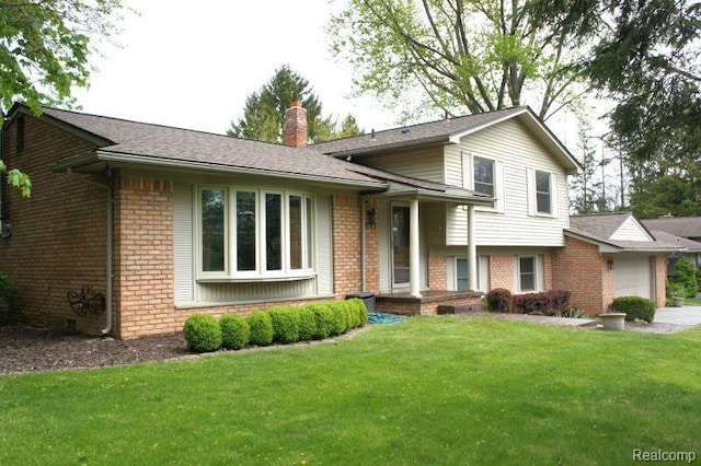 1616 Mark Hopkins Rd, Bloomfield Hills, MI 48302 - tri-level home with a chimney, an attached garage, brick siding, and a front yard