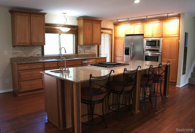 1616 Mark Hopkins Rd, Bloomfield Hills, MI 48302 - kitchen featuring stainless steel appliances, an island with sink, a sink, and decorative backsplash