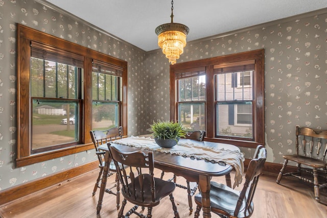 810 N Superior St, Albion, MI 49224 - dining area featuring wallpapered walls, wood finished floors, a chandelier, and baseboards