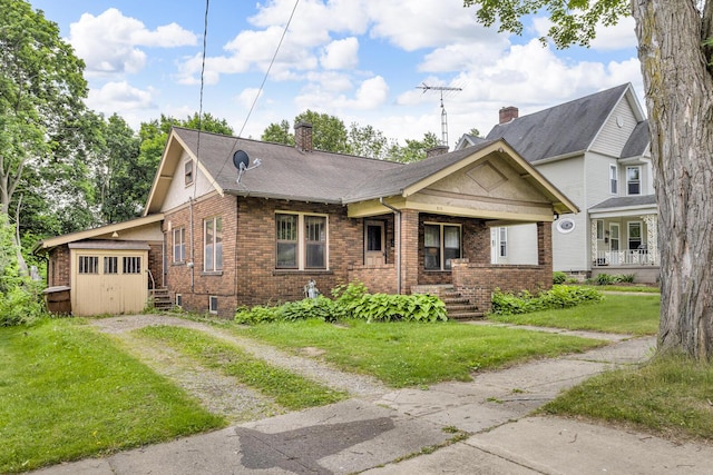 810 N Superior St, Albion, MI 49224 - view of front of house with dirt driveway, brick siding, a front lawn, an attached garage, and a chimney