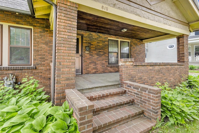 810 N Superior St, Albion, MI 49224 - doorway to property featuring brick siding and a porch