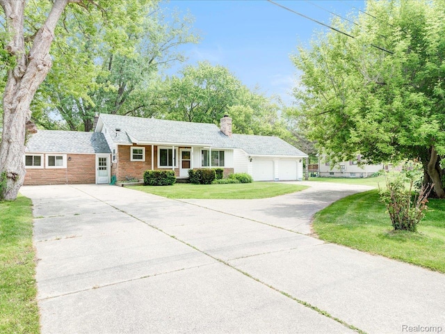 641 Michigan Ave, Marysville, MI 48040 - single story home featuring asphalt driveway, a chimney, a front yard, and an attached garage