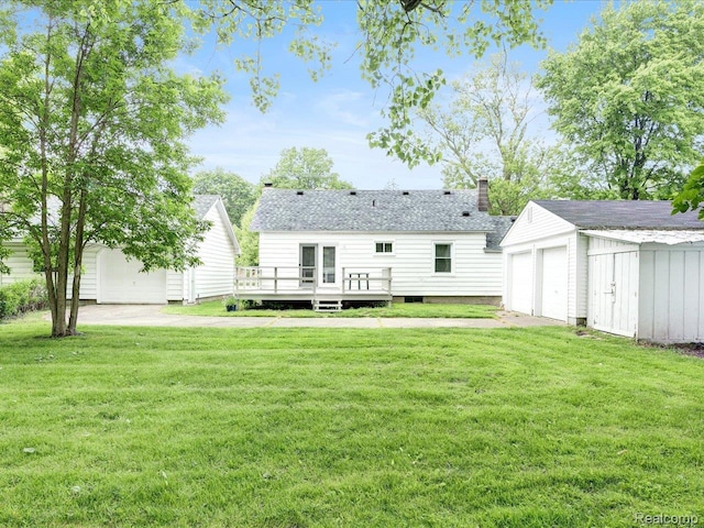 641 Michigan Ave, Marysville, MI 48040 - rear view of property featuring an outdoor structure, a wooden deck, a lawn, and a garage