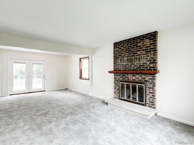 641 Michigan Ave, Marysville, MI 48040 - unfurnished living room featuring carpet, plenty of natural light, a brick fireplace, and baseboards