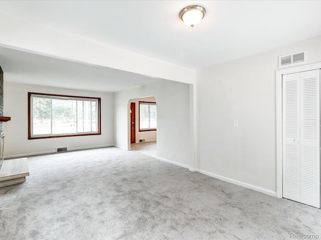 641 Michigan Ave, Marysville, MI 48040 - unfurnished living room with arched walkways, carpet, and baseboards