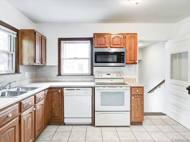 641 Michigan Ave, Marysville, MI 48040 - kitchen featuring white appliances, a sink, light countertops, light tile patterned floors, and plenty of natural light