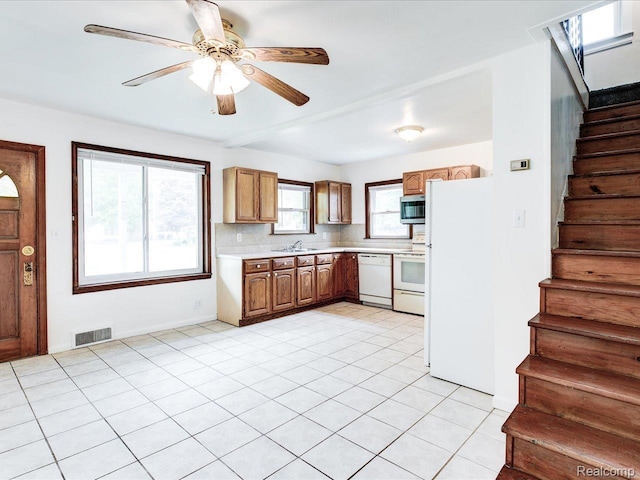 641 Michigan Ave, Marysville, MI 48040 - kitchen featuring white appliances, a sink, light countertops, a ceiling fan, and tasteful backsplash