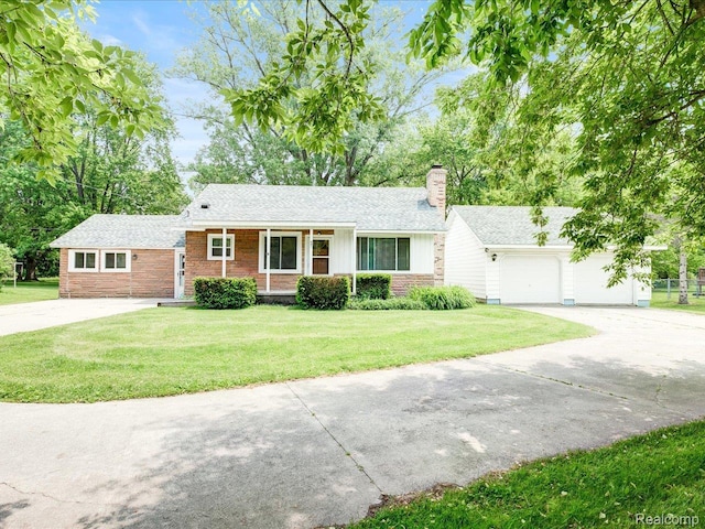 641 Michigan Ave, Marysville, MI 48040 - view of front of house featuring a chimney, concrete driveway, a front lawn, and brick siding