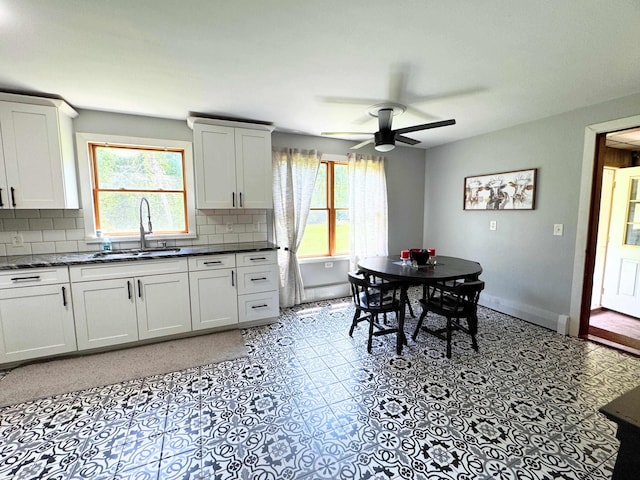 10073 Mcafee Dr, Montrose, MI 48457 - kitchen featuring plenty of natural light, tasteful backsplash, a ceiling fan, and dark countertops
