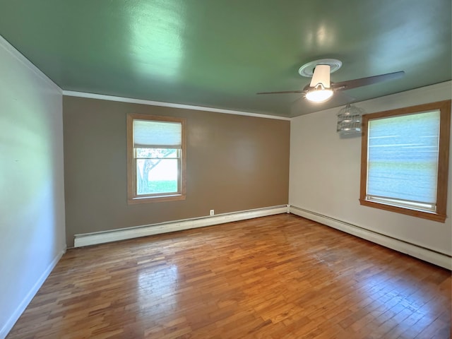 10073 Mcafee Dr, Montrose, MI 48457 - empty room featuring a ceiling fan, a baseboard heating unit, wood finished floors, ornamental molding, and baseboards