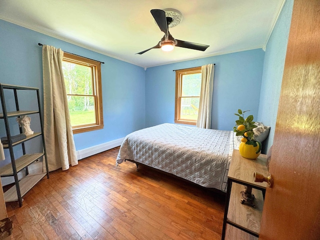 10073 Mcafee Dr, Montrose, MI 48457 - bedroom featuring ornamental molding, multiple windows, wood-type flooring, baseboards, and a ceiling fan