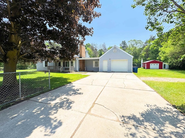 10073 Mcafee Dr, Montrose, MI 48457 - view of front of home with concrete driveway, a chimney, and a garage