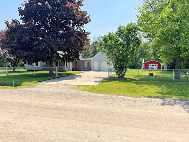 10073 Mcafee Dr, Montrose, MI 48457 - view of property hidden behind natural elements featuring driveway and a garage
