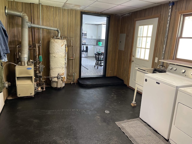 10073 Mcafee Dr, Montrose, MI 48457 - washroom with washing machine and dryer, wooden walls, and water heater