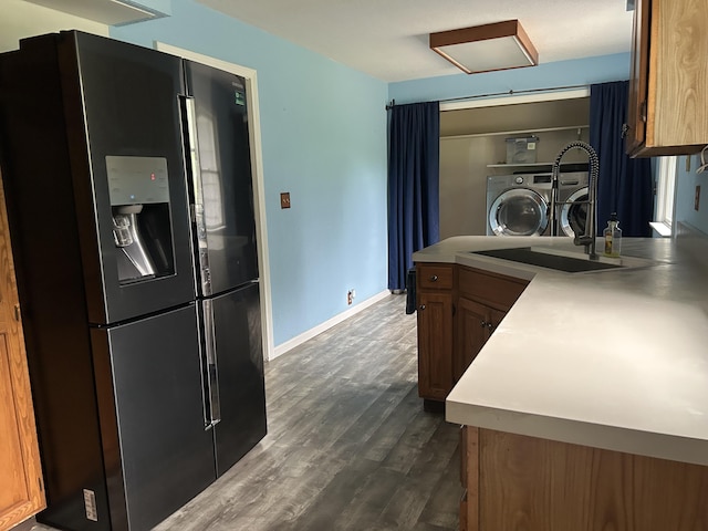 201 Goodell Ave, Colon, MI 49040 - kitchen with fridge with ice dispenser, washer and clothes dryer, dark wood-style flooring, light countertops, and a peninsula