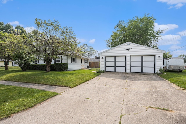 1012 E Hatch St, Sturgis, MI 49091 - view of front of home featuring an outbuilding, a detached garage, and a front lawn