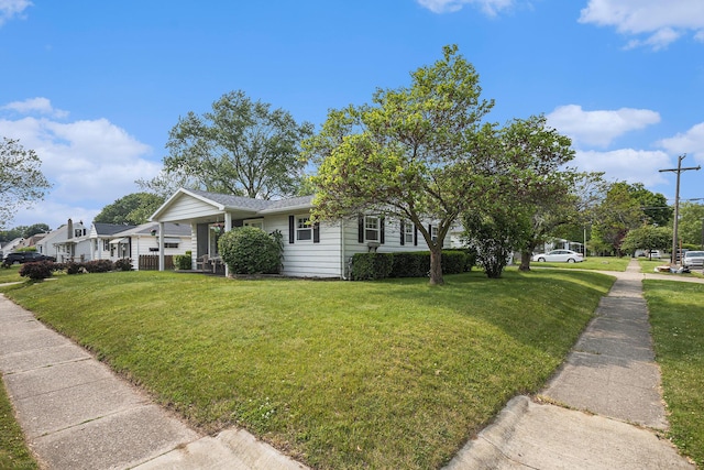 1012 E Hatch St, Sturgis, MI 49091 - view of side of property with a yard, covered porch, and a shingled roof