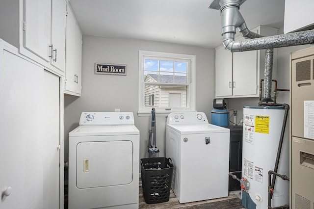 1012 E Hatch St, Sturgis, MI 49091 - laundry area featuring washer and dryer, water heater, cabinet space, and dark wood-style floors