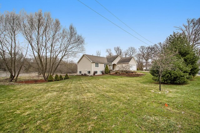 1200 Schuring Rd, Portage, MI 49024 - view of side of home featuring a lawn and a garage