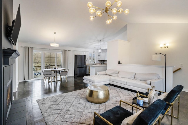 1200 Schuring Rd, Portage, MI 49024 - living area featuring a fireplace, baseboards, dark wood finished floors, a chandelier, and lofted ceiling