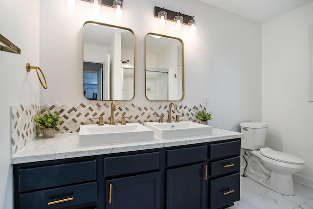 1200 Schuring Rd, Portage, MI 49024 - full bath featuring double vanity, tasteful backsplash, toilet, and marble finish flooring