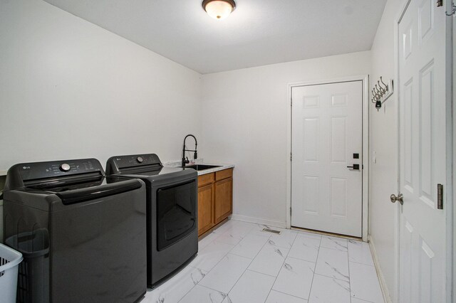 1200 Schuring Rd, Portage, MI 49024 - washroom with washer and dryer, cabinet space, light marble finish floors, and baseboards