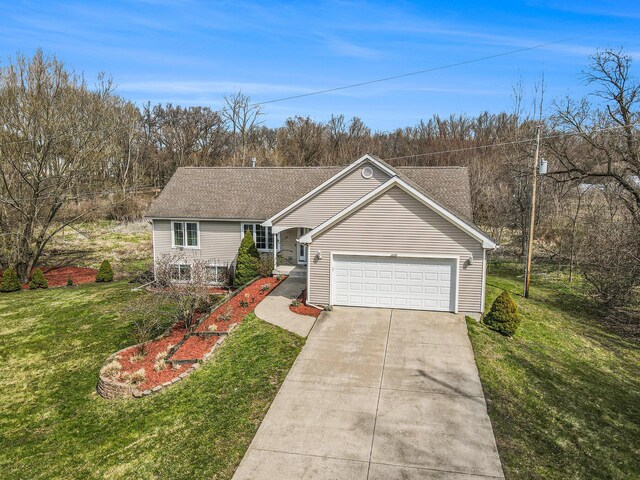 1200 Schuring Rd, Portage, MI 49024 - view of front facade with concrete driveway, a front yard, an attached garage, and a shingled roof