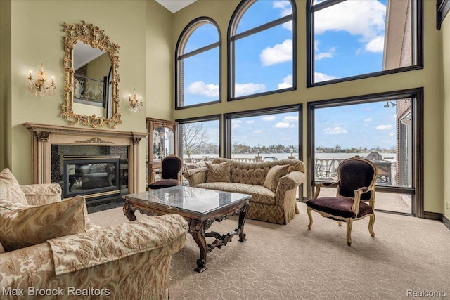 985 James K Blvd, Pontiac, MI 48341 - living area with a premium fireplace, carpet floors, a towering ceiling, and baseboards
