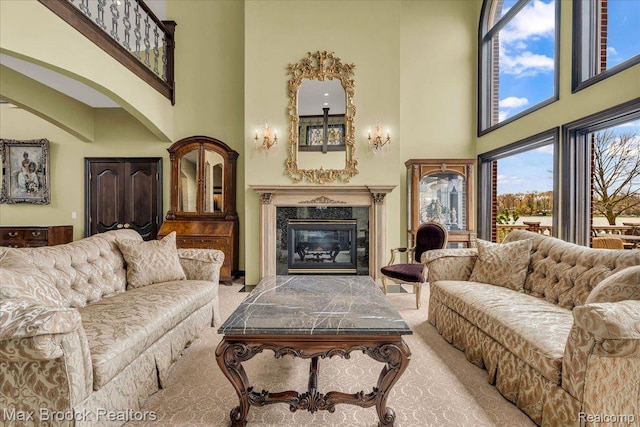 985 James K Blvd, Pontiac, MI 48341 - living area featuring a fireplace, a high ceiling, carpet, and arched walkways