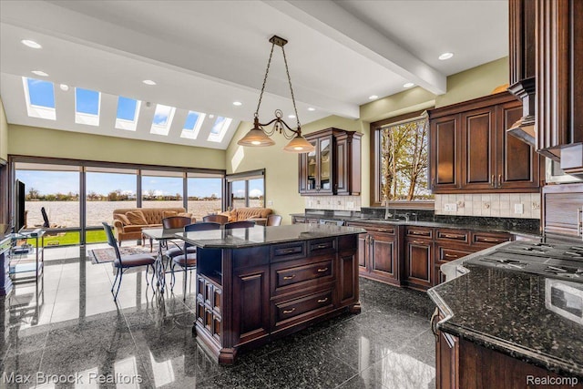 985 James K Blvd, Pontiac, MI 48341 - kitchen with granite tiled floors, decorative backsplash, recessed lighting, dark stone countertops, and decorative light fixtures