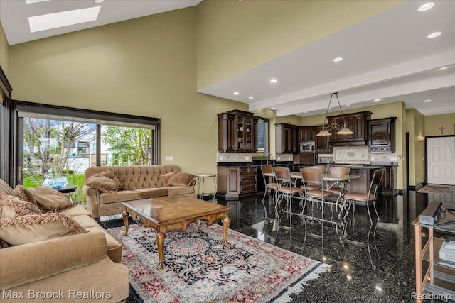 985 James K Blvd, Pontiac, MI 48341 - living room with granite tiled floors, a skylight, recessed lighting, and a towering ceiling