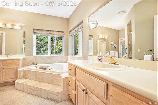 3050 High Hillcrest Dr, Howell, MI 48843 - bathroom featuring a garden tub, two vanities, and tile patterned floors
