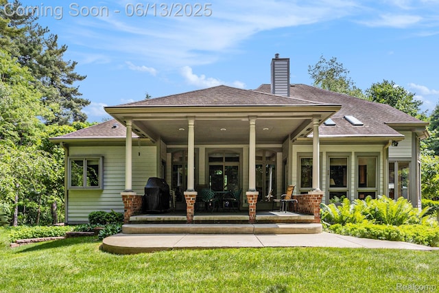 3050 High Hillcrest Dr, Howell, MI 48843 - rear view of property featuring a chimney, a yard, covered porch, and roof with shingles