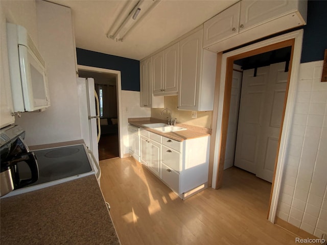 3255 Goodrich St, Ferndale, MI 48220 - kitchen featuring white appliances, light wood finished floors, and white cabinetry
